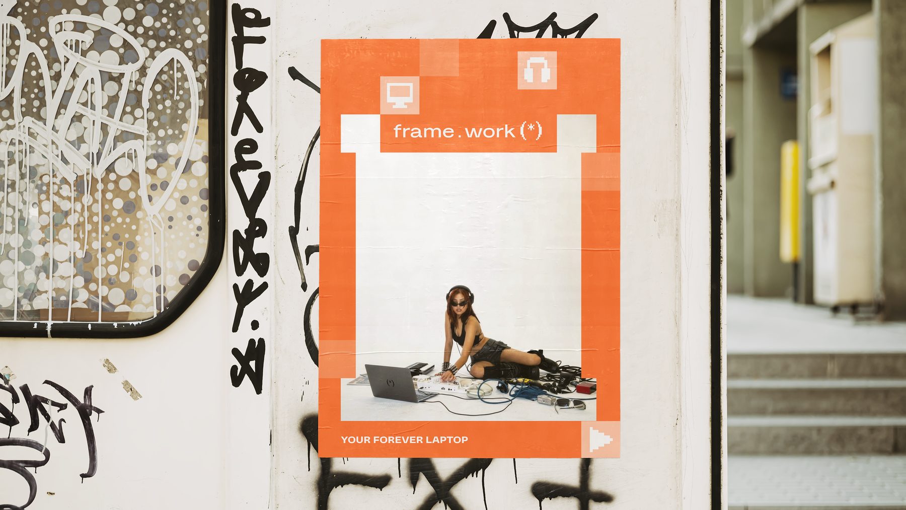 frame.work poster pasted on a graffitied city wall